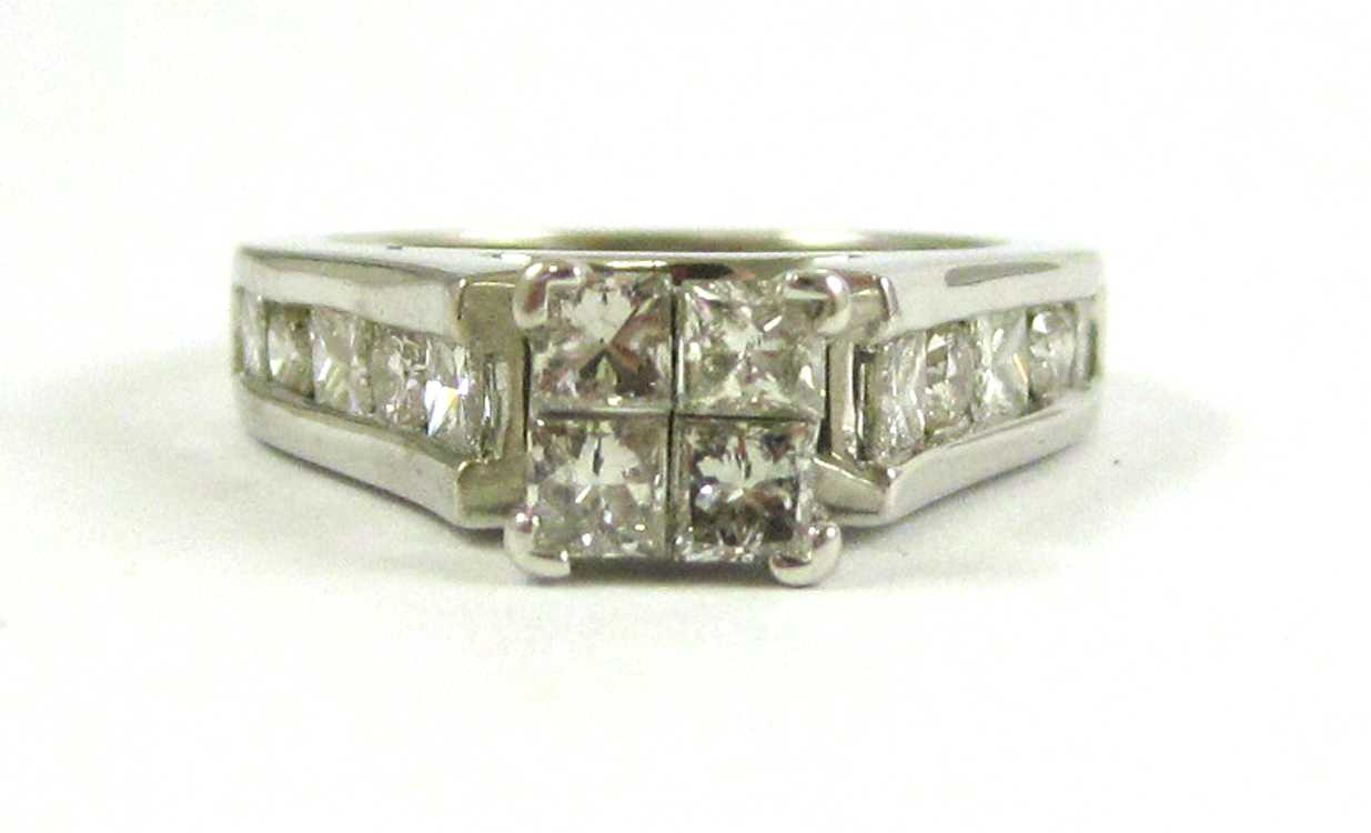 Appraisal: DIAMOND AND FOURTEEN KARAT WHITE GOLD RING with three princess-cut