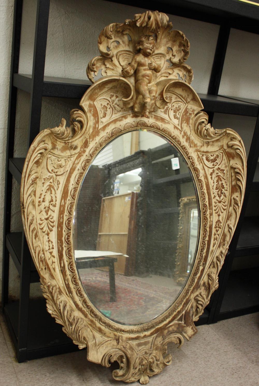 Appraisal: LARGE OVAL WALL MIRROR Italian Baroque style th century in