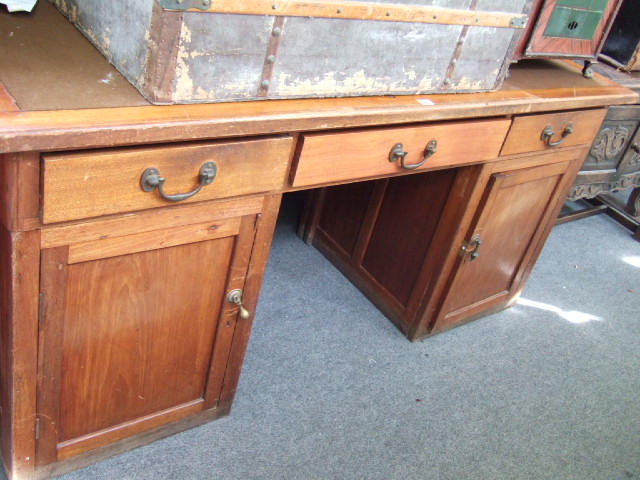 Appraisal: A th century mahogany partners desk with three frieze drawers