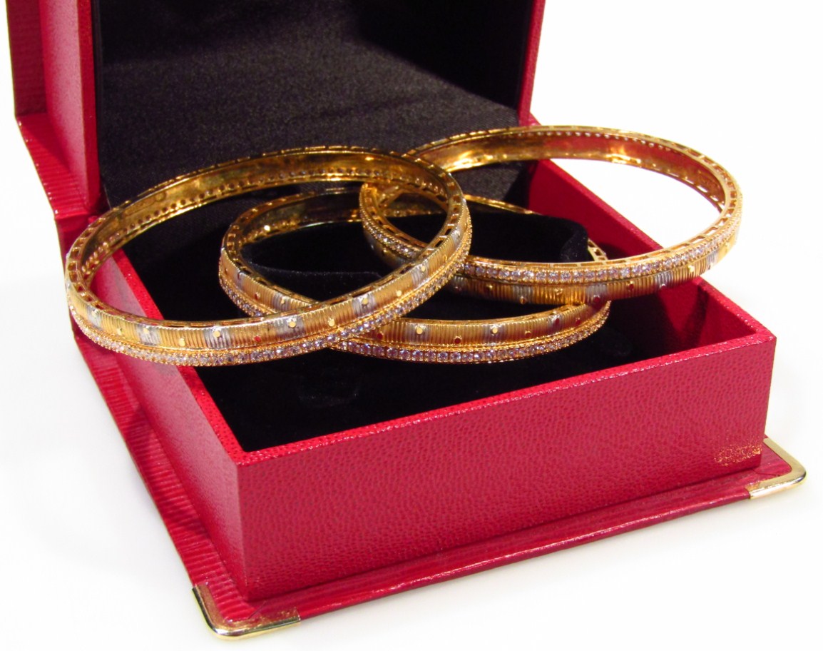 Appraisal: Three Middle Eastern fancy design bangles each set with white