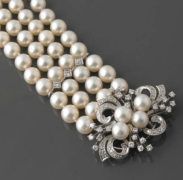 Appraisal: A four strand cultured pearl bracelet with diamond and white