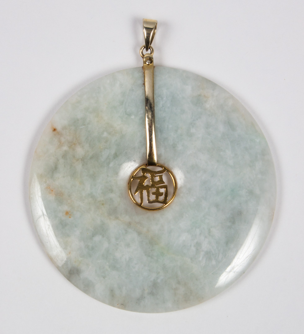 Appraisal: Chinese K gold pi disk green stone pendant pi disk