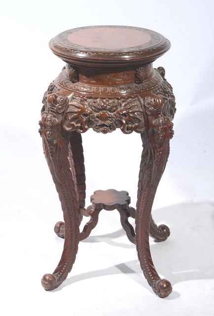 Appraisal: A CHINESE STAINED HARDWOOD URN STAND with dragon carved supports