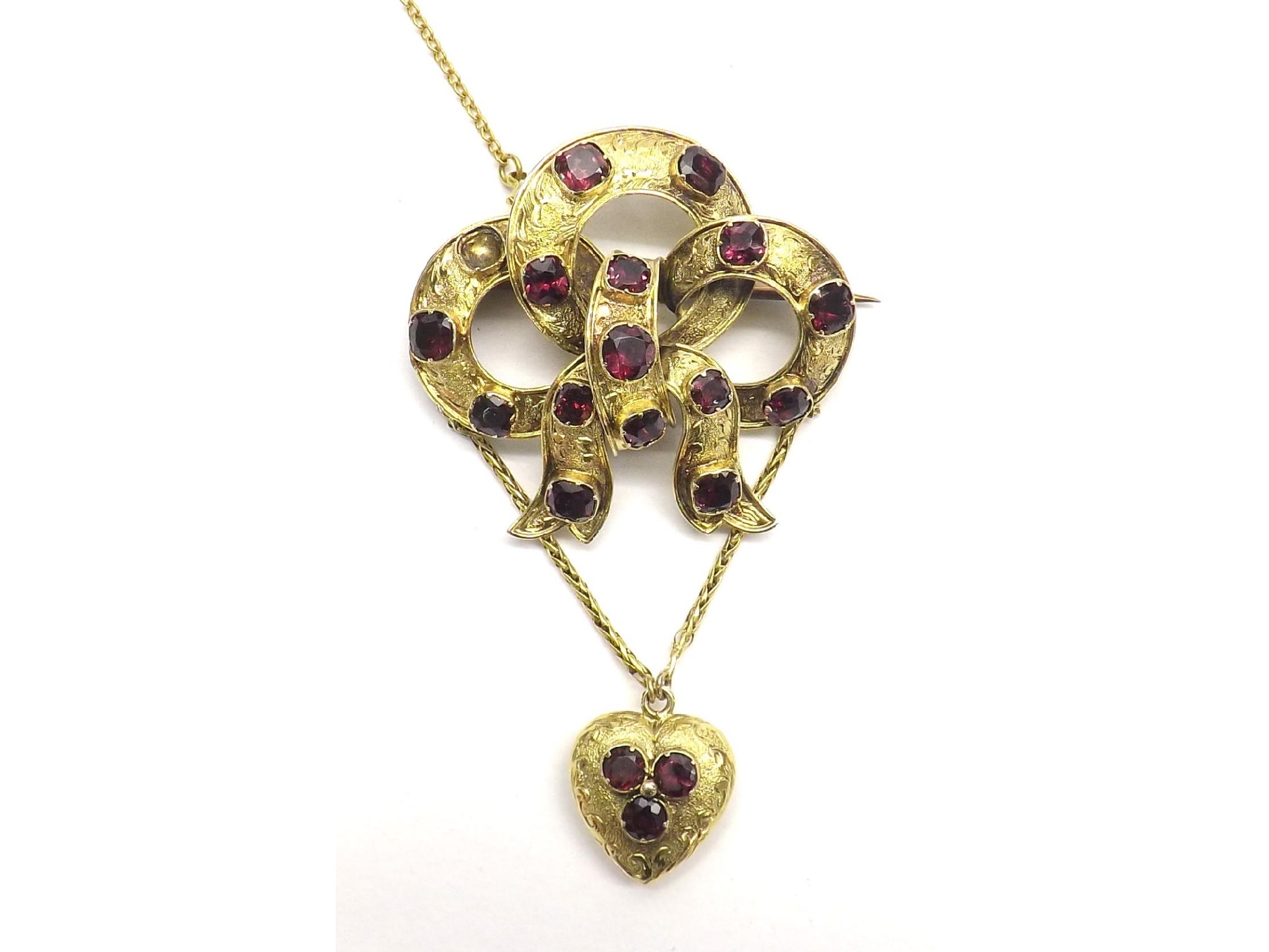 Appraisal: Victorian garnet set knot design brooch with a chain heart