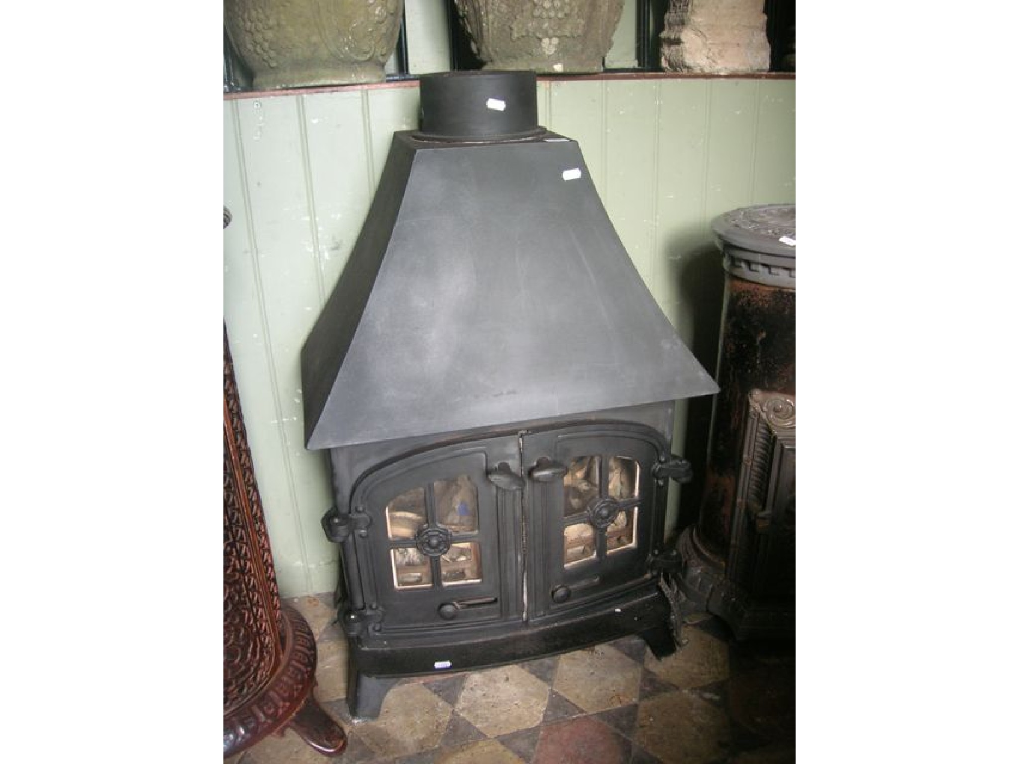 Appraisal: A cast iron multi-fuel stove enclosed by a pair of