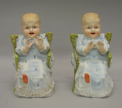 Appraisal: Pair of unmarked bisque boy babies sitting in green wicker