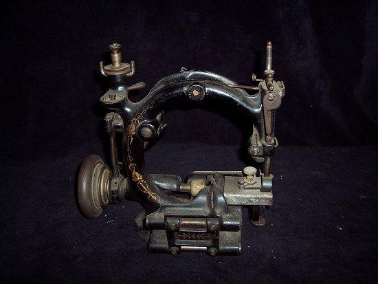 Appraisal: A sewing machine with twin supports and gilt decoration cm