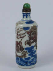 Appraisal: A Chinese ceramic snuff bottle decorated with a dragon amid