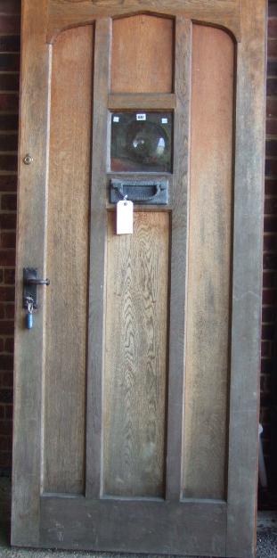 Appraisal: An oak door with three arched vertical panels and a