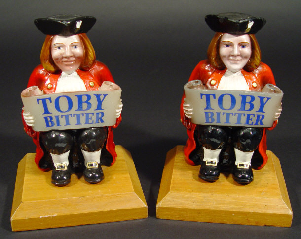 Appraisal: Two Toby Bitter Brewery advertising pump covers on hardwood stands