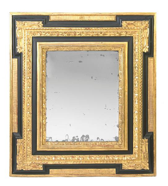 Appraisal: An Italian Baroque style giltwood and ebonized mirror The rectangular