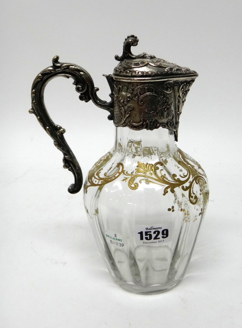 Appraisal: A silver plated metal mounted glass claret jug the body