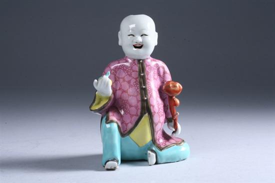 Appraisal: CHINESE FAMILLE ROSE PORCELAIN FIGURE OF BOY Qing Dynasty Seated