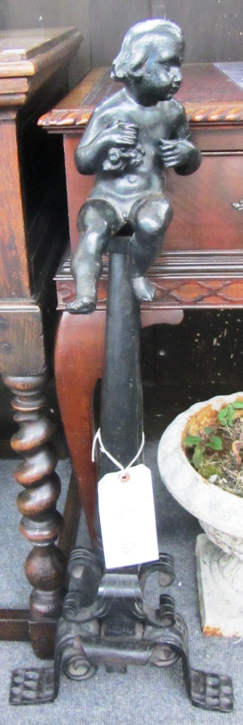 Appraisal: A pair of cast iron and wrought iron figural andirons