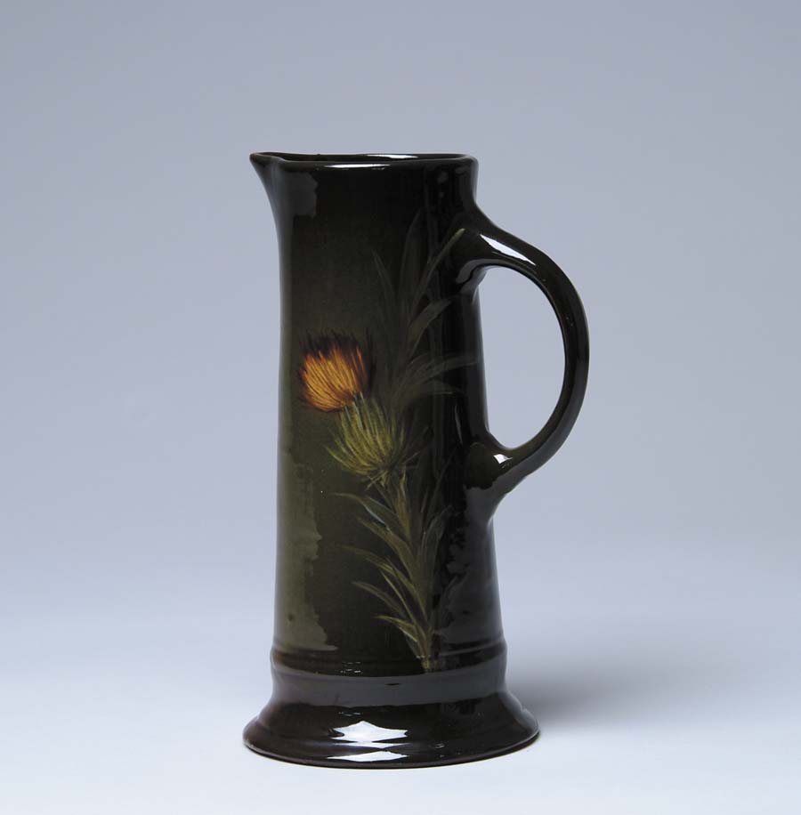 Appraisal: WELLER THISTLE TANKARD Brown and green glaze handled tankard with