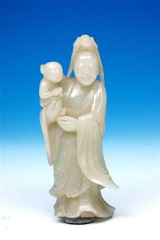 Appraisal: A Chinese jade figure of Quan-Yin holding a child high