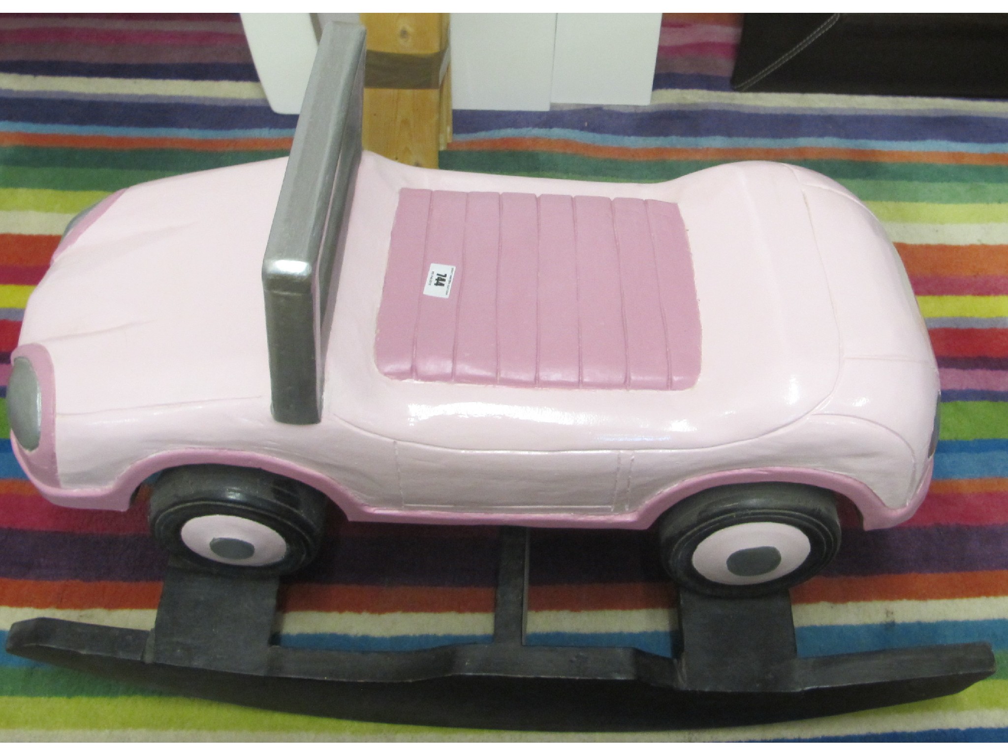 Appraisal: A wooden rocker pink car