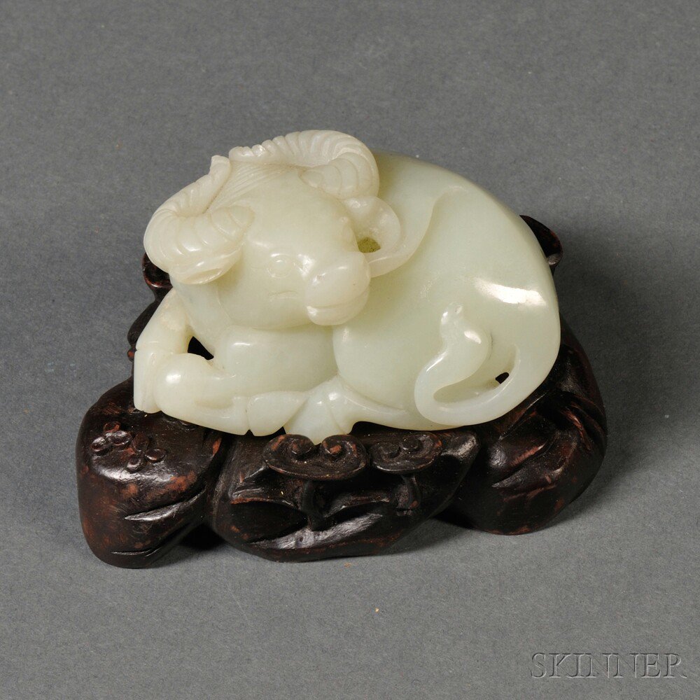 Appraisal: Jade Ram China seated on an elaborately carved wood stand