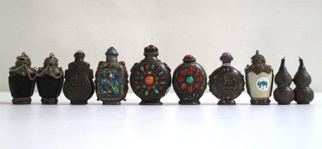 Appraisal: NINE SNUFF BOTTLES made of wood bone silver metal coral