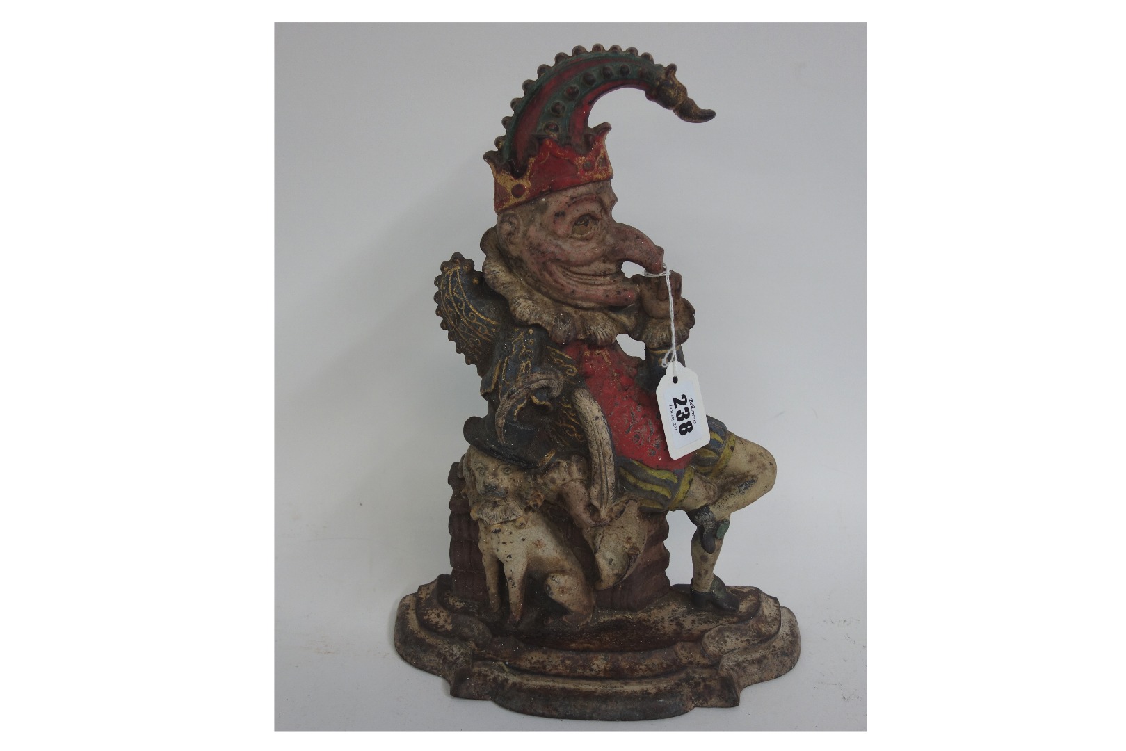 Appraisal: A Victorian polychrome painted cast iron 'Mr Punch' door stop