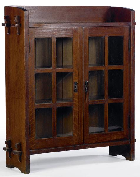 Appraisal: GUSTAV STICKLEY Rare and early double-door bookcase of diminutive size