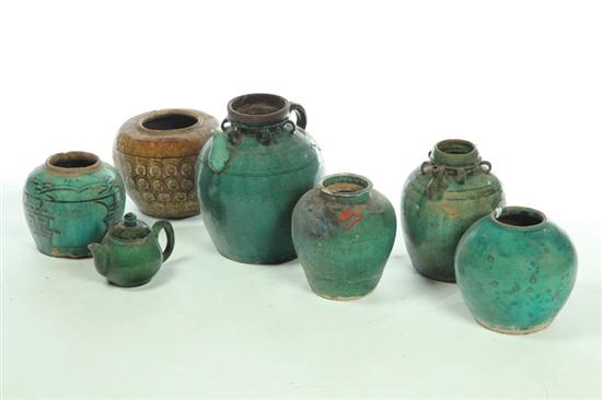 Appraisal: SEVEN STORAGE JARS AND TEAPOT Asian mid th century redware