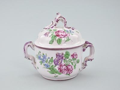 Appraisal: A French Faience Covered Bowl With a pink tinted background