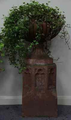 Appraisal: A terracotta lobbed urn on a Gothic style plinth cm