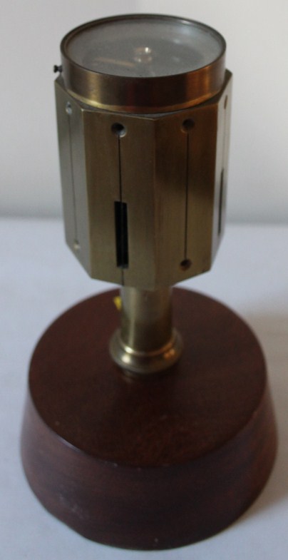 Appraisal: A tabletop compass in brass on a mahogany plinth cm