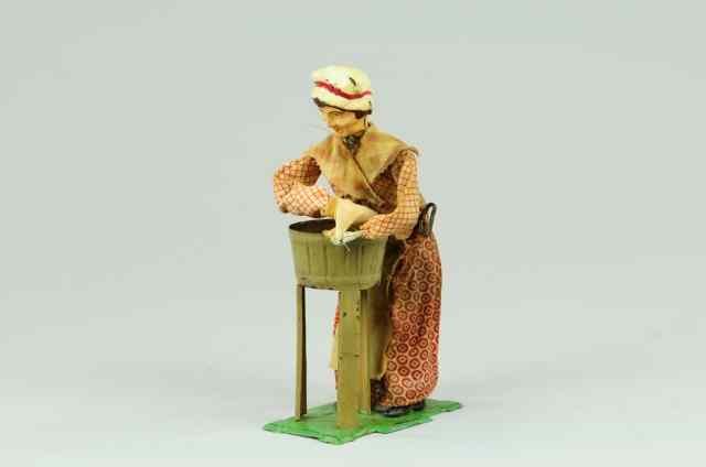 Appraisal: MARTIN WASHING WOMAN TOY Hand painted tin clockwork motions involve