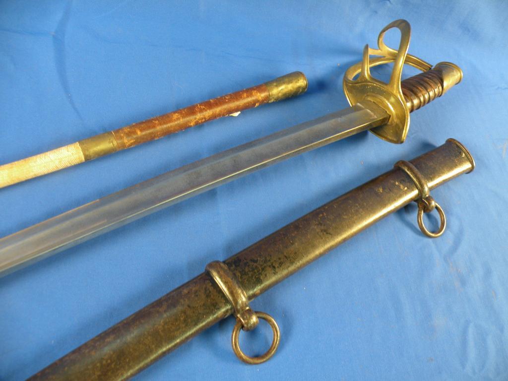 Appraisal: A dress sword with a black painted scabbard pierced brass