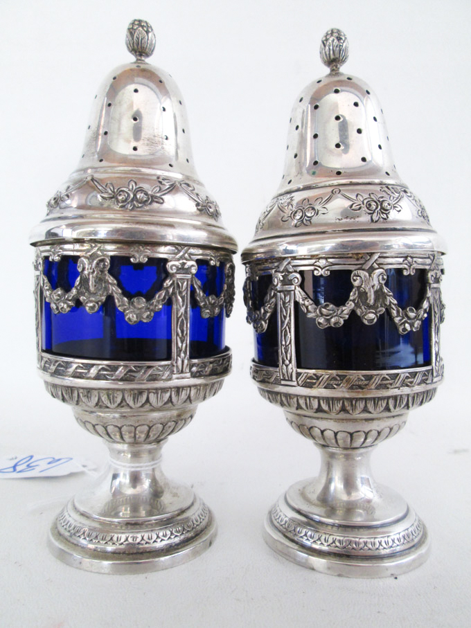 Appraisal: PAIR GERMAN FINE SILVER SUGAR CASTERS with cobalt blue glass