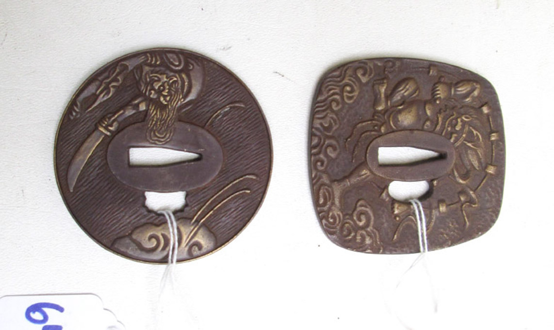 Appraisal: TWO DECORATIVE CAST BRONZE TSUBA'S the first a trapezoid shape