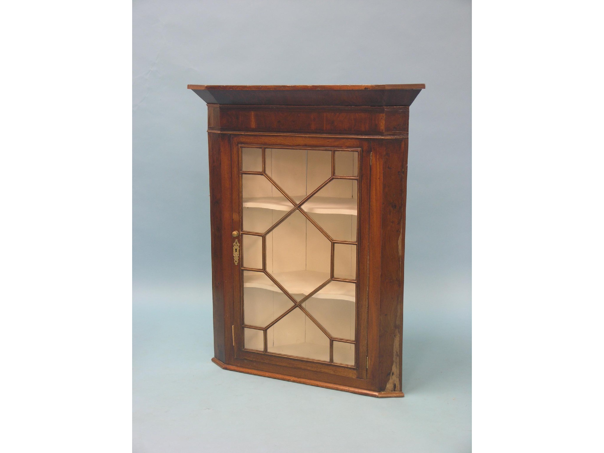 Appraisal: A Victorian mahogany corner cabinet single astragal-glazed door enclosing cream-painted