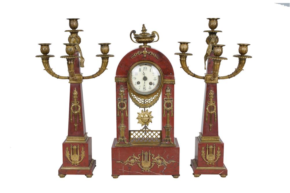 Appraisal: ROUGE MARBLE CLOCK GARNITUREcomprising a clock and two candelabra with