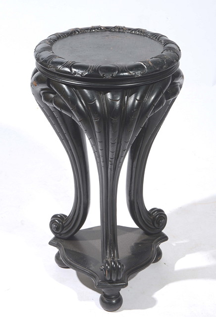 Appraisal: A CHINESE EBONISED URN STAND with carved top and exaggerated