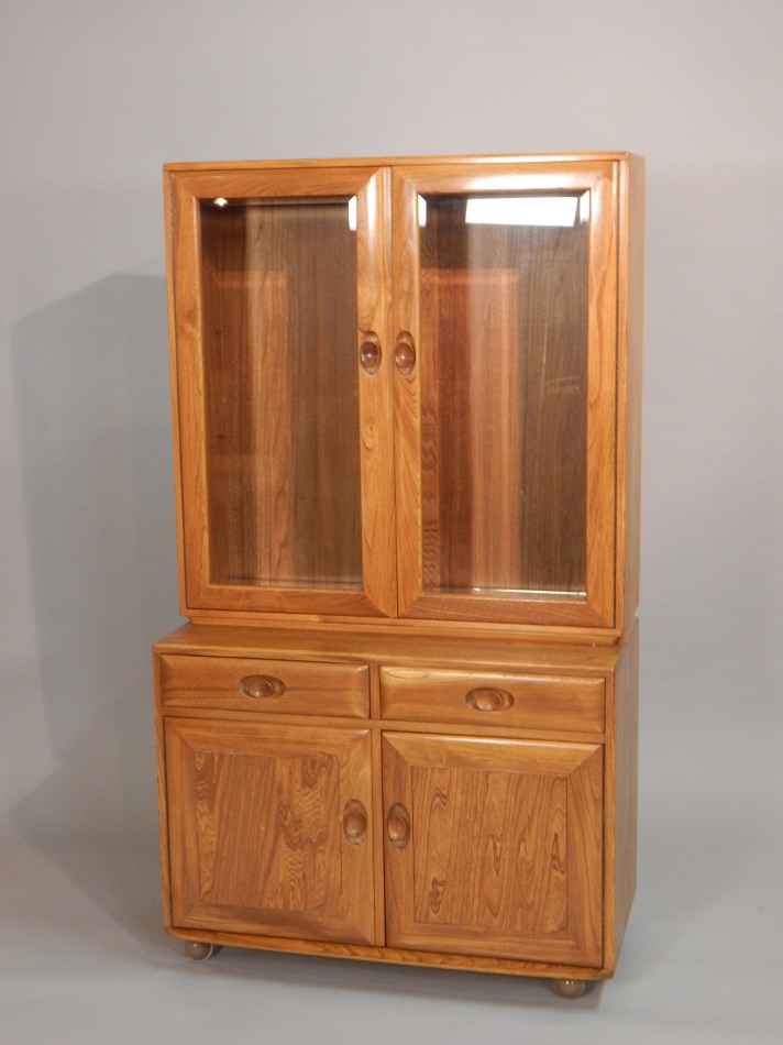 Appraisal: An Ercol light elm retro style display cabinet the top