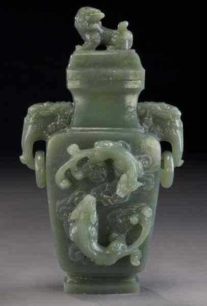 Appraisal: Chinese carved jade vase with an eagle's head lion finial