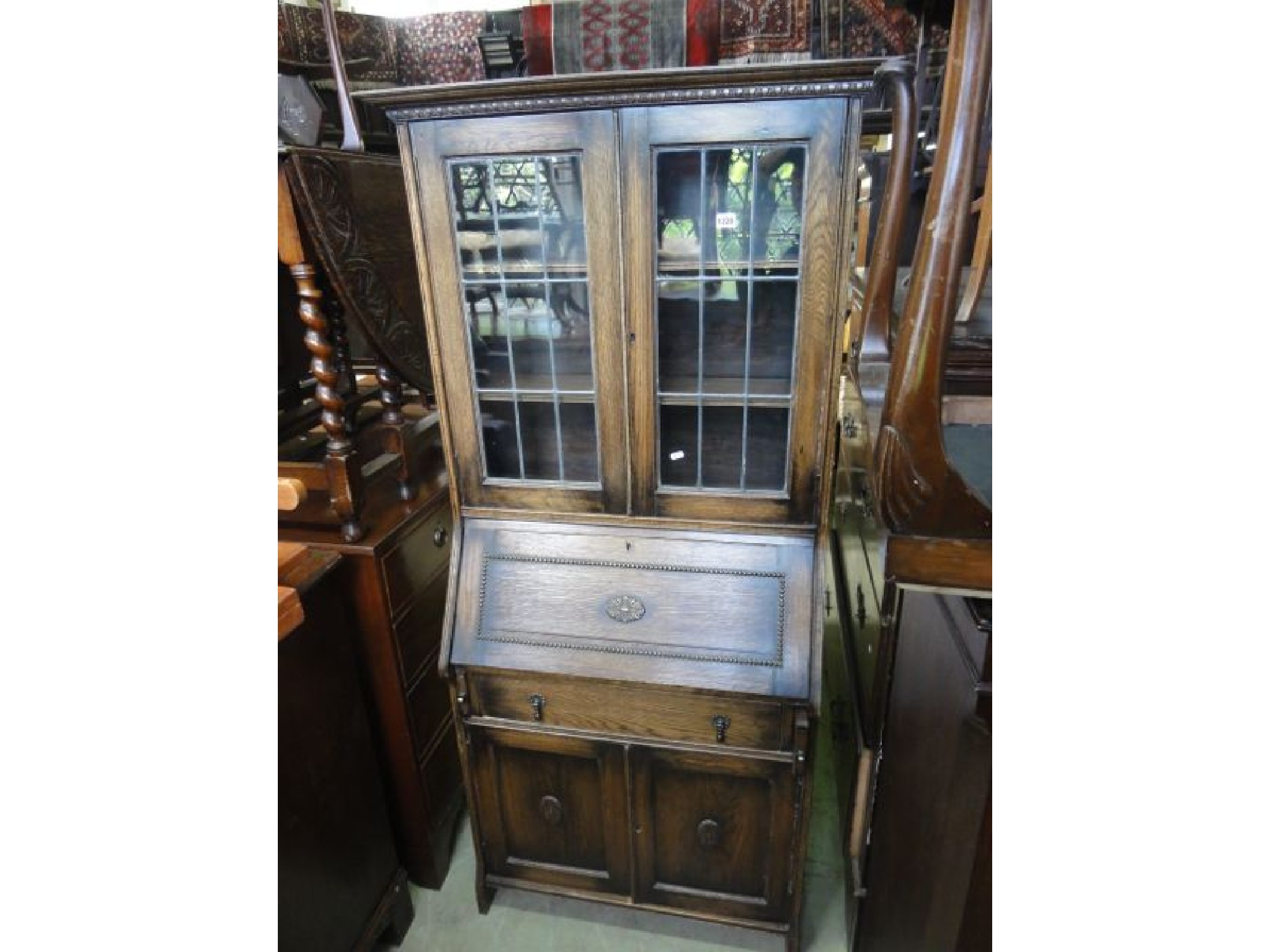 Appraisal: An Edwardian slim oak bureau bookcase combination the upper section