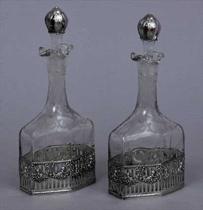 Appraisal: PAIR OF GERMAN SILVER CASED ENGRAVED GLASS CRUETS AND STOPPERS