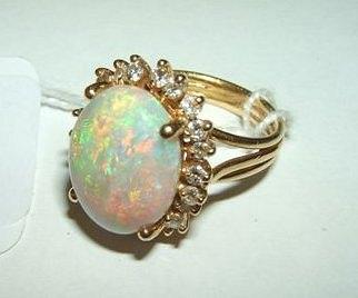 Appraisal: An opal and diamond set dress ring the oval claw