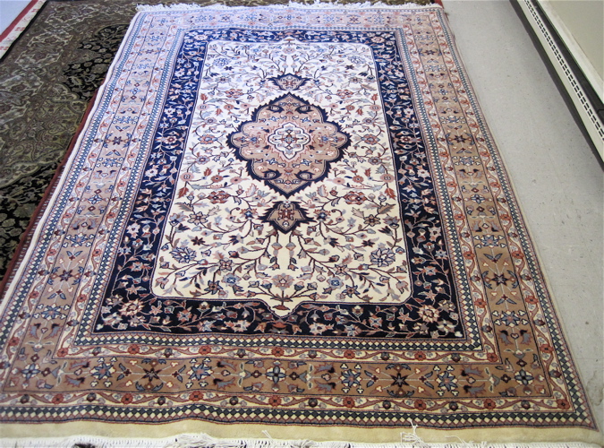 Appraisal: HAND KNOTTED ORIENTAL CARPET Indo-Persian floral and central floral medallion