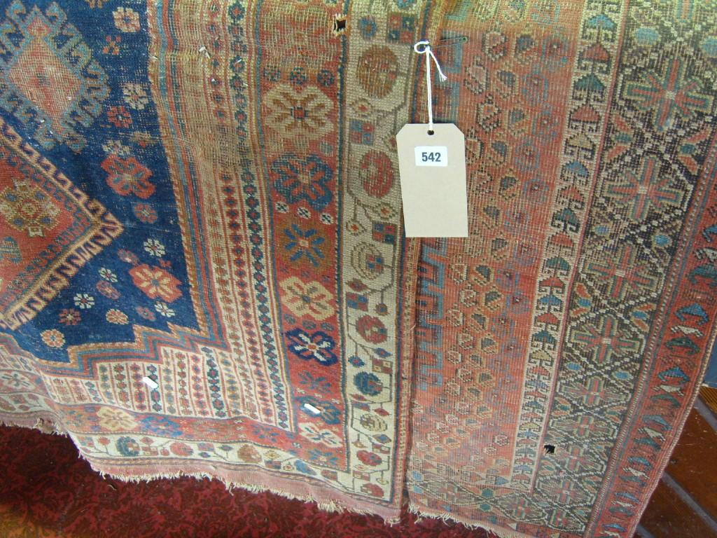 Appraisal: A blue ground eastern wool rug with stylised floral and