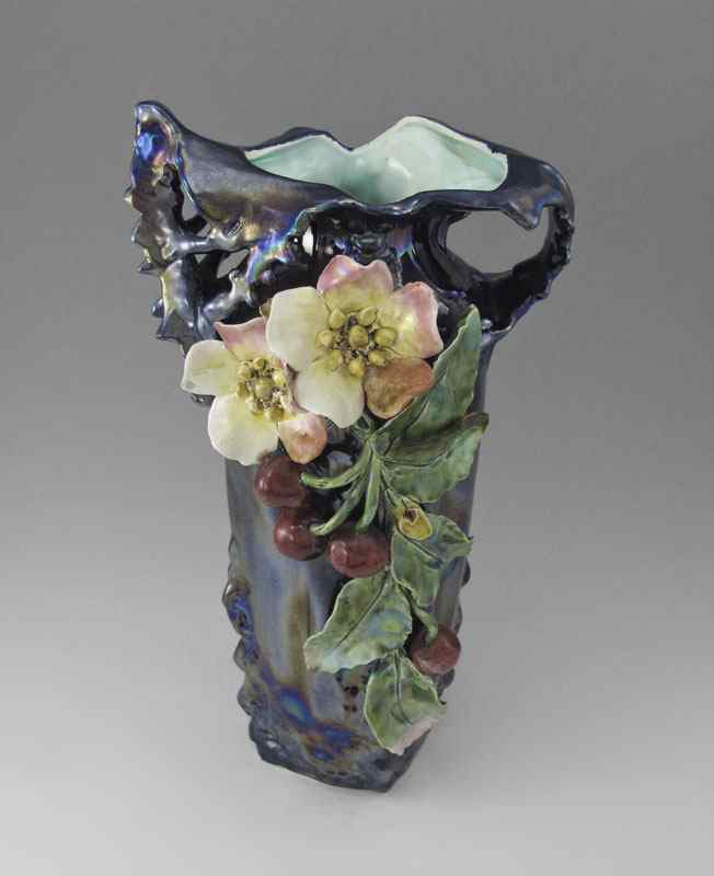 Appraisal: IRIDESCENT GLAZE FLORAL POTTERY VASE Flower and berry motif Incised