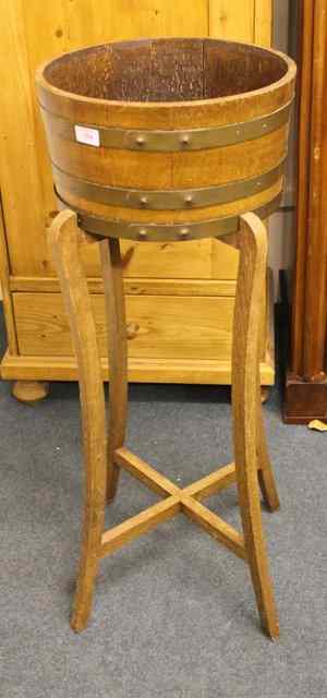 Appraisal: AN OAK BRASS BOUND PLANTER on stand of circular form