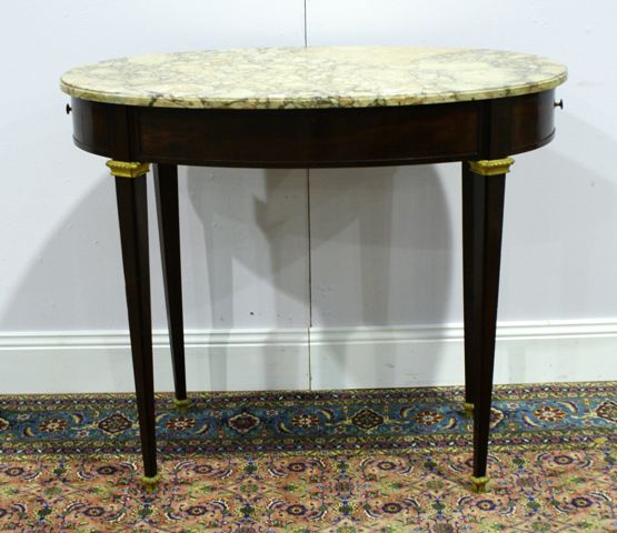 Appraisal: A Louis XVI style mahogany and marble oval occasional table