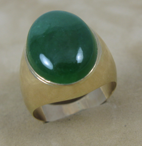 Appraisal: MAN'S GREEN JADE RING k yellow gold and centering an