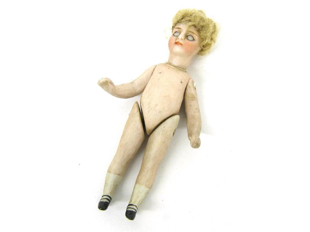 Appraisal: Miniature porcelain doll with closing eyes and articulated head and