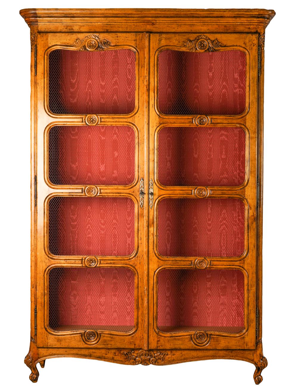 Appraisal: FRENCH PROVINCIAL WALNUT BIBLIOTHEQUEthe wire mesh-inset doors enclosing a moire