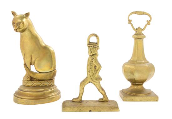 Appraisal: Sale Lot Three Brass Doorstops comprising an example depicting a